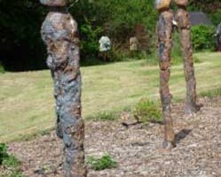 Three standing figures. 
In the garden at Corgam

 
